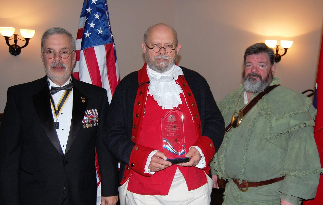 Steve Gaines, center, receives the award for Color Guardsman of the Year for 2018.